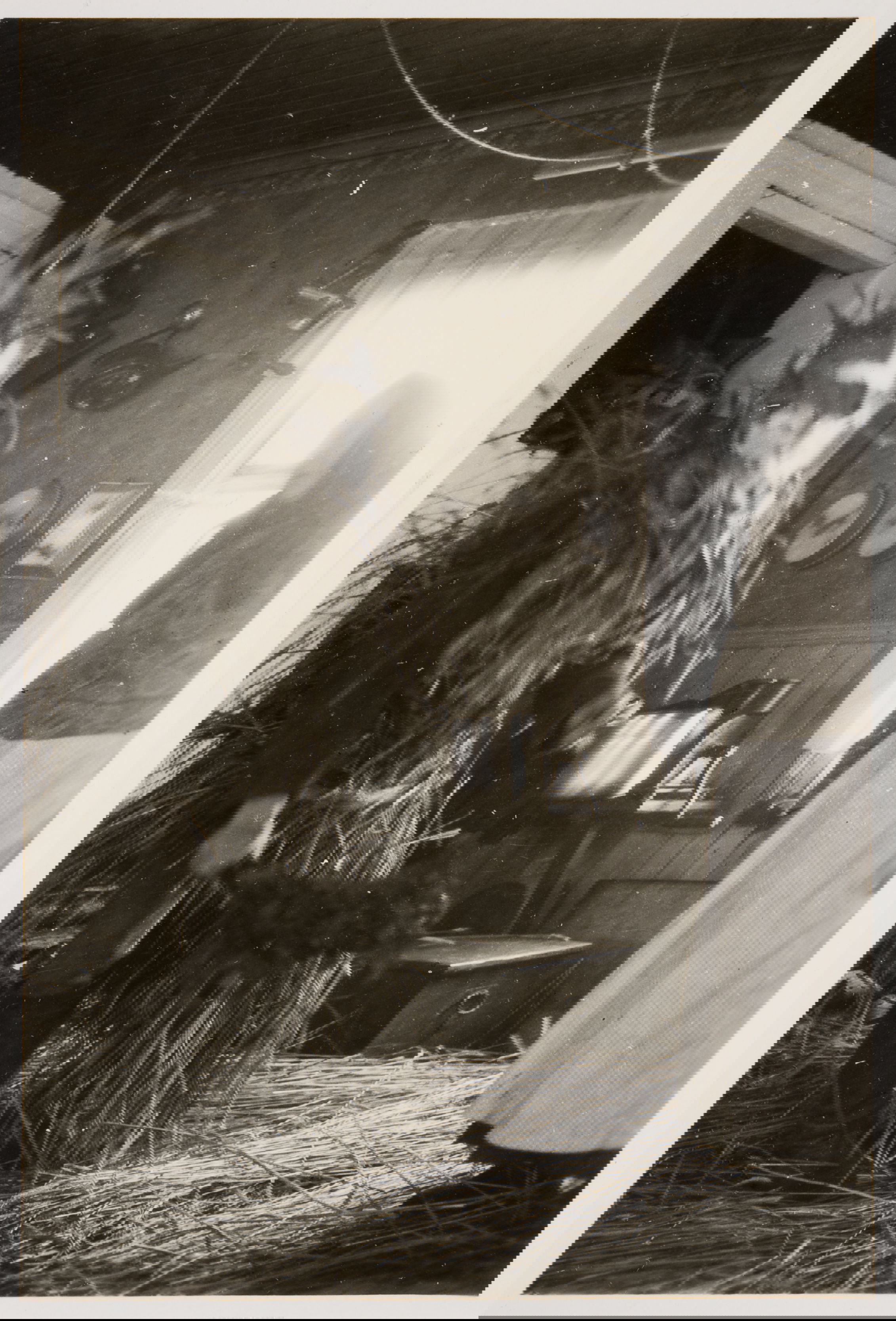 Photograph of a figure covered in straw